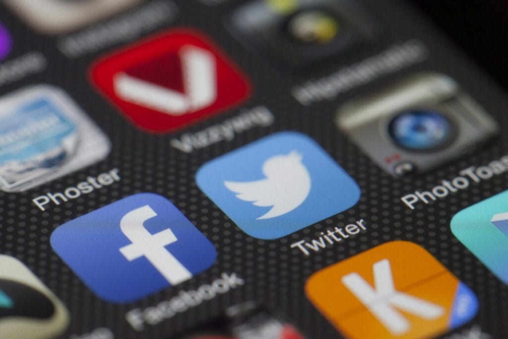 pexels-photo-267389-267389 A detailed close-up of social media icons on a smartphone screen, including Facebook and Twitter.