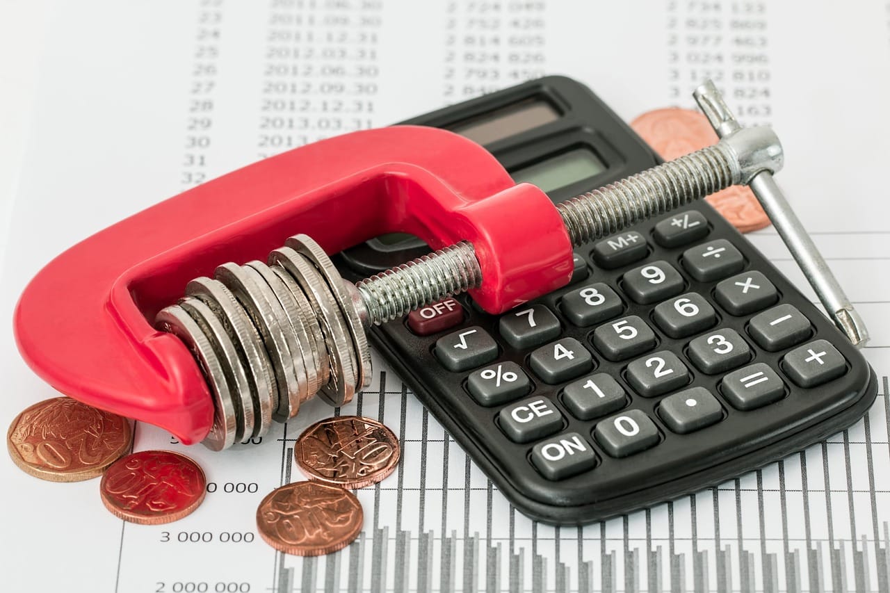 Image showing coins in a vise used for Budget Plan Pro's blog on the Debt Avalanche Method